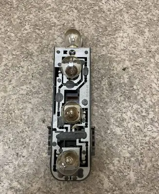 Tail light bulb cover holder