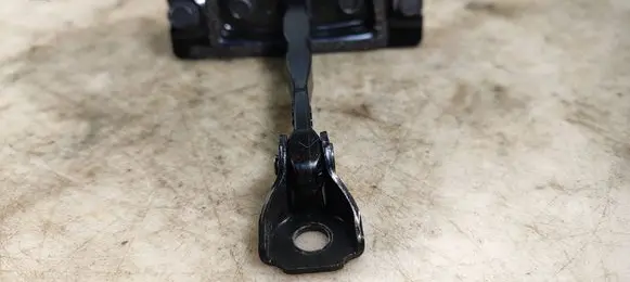 Front door check strap stopper