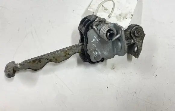 Front door check strap stopper