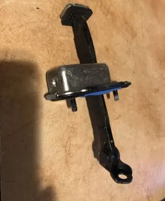 Front door check strap stopper