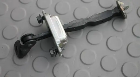 Front door check strap stopper