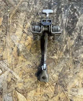 Front door check strap stopper