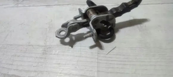 Front door check strap stopper