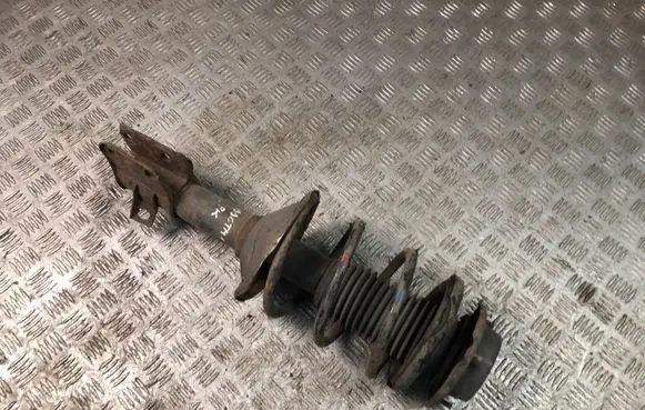 Subaru Impreza I Front shock absorber with coil spring
