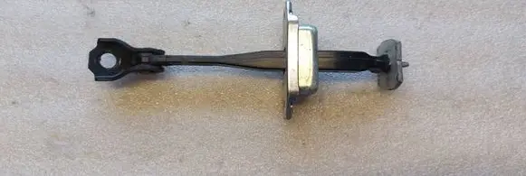Front door check strap stopper