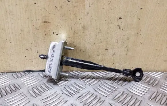 Front door check strap stopper