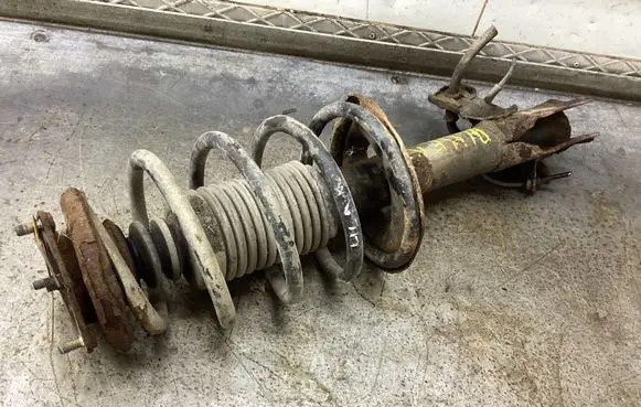 Nissan Almera N16 Front shock absorber with coil spring