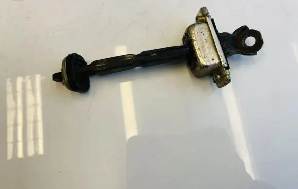 Chevrolet Tacuma Rear door check strap stopper