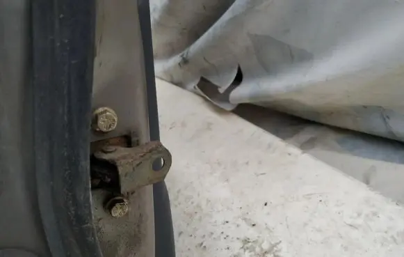Front door check strap stopper