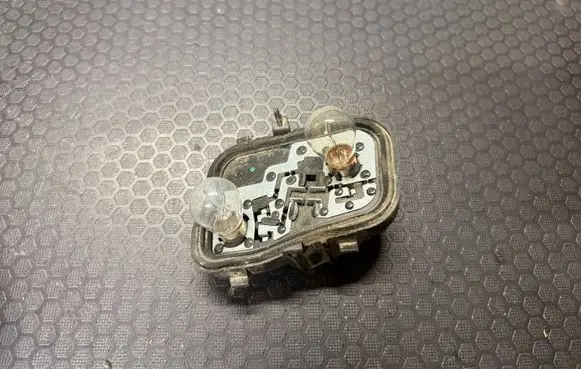 Tail light bulb cover holder