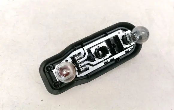 Tail light bulb cover holder