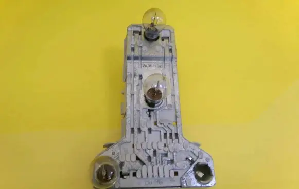 Tail light bulb cover holder