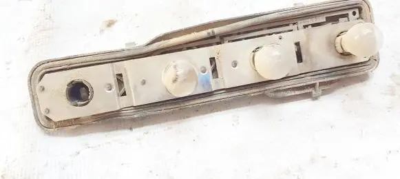 Tail light bulb cover holder