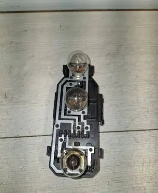 Tail light bulb cover holder