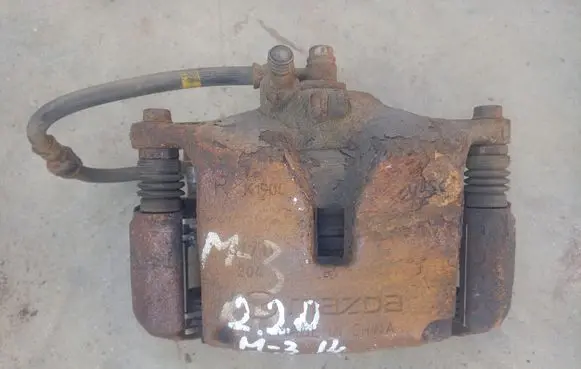 Mazda 3 II Front brake caliper