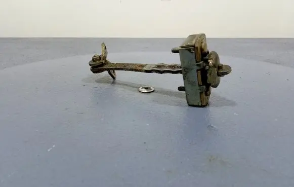 Front door check strap stopper