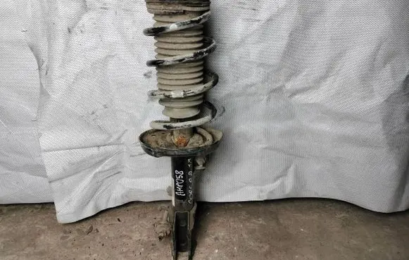 Opel Corsa D Front shock absorber with coil spring 13399042