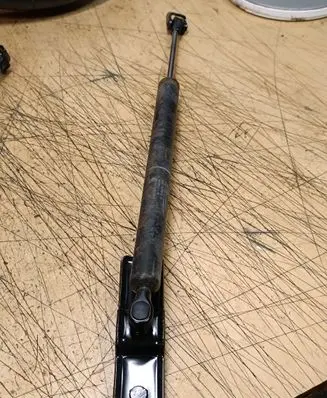 Front door check strap stopper