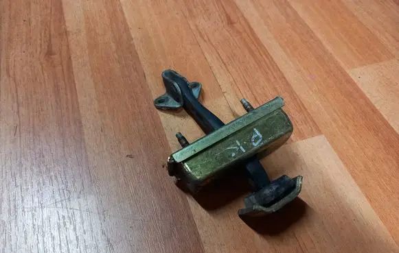 Front door check strap stopper