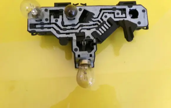 Tail light bulb cover holder