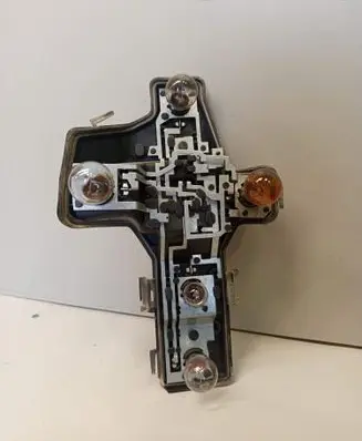 Tail light bulb cover holder