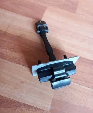 Front door check strap stopper