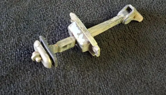 Front door check strap stopper