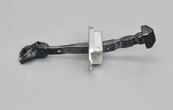 Front door check strap stopper