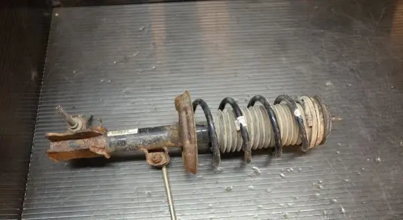 Opel Corsa D Front shock absorber with coil spring 13214357