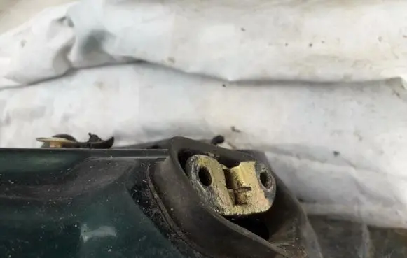 Front door check strap stopper
