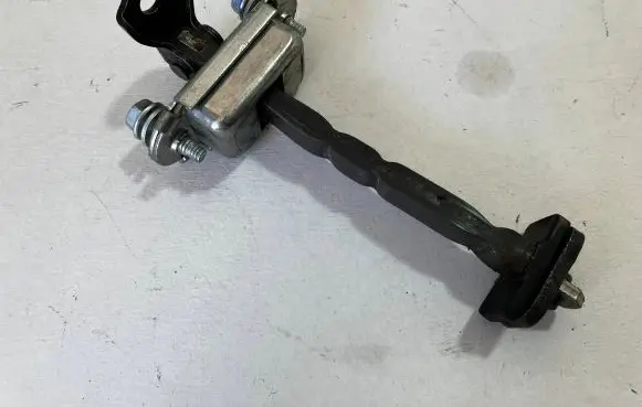 Front door check strap stopper