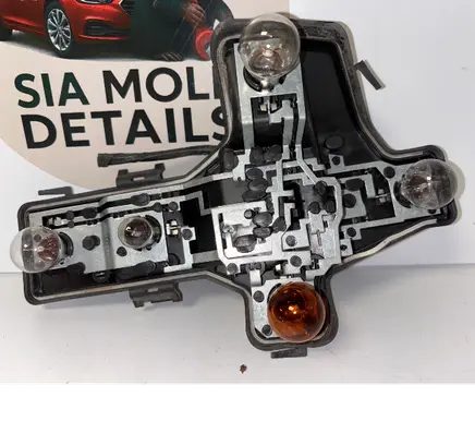 Tail light bulb cover holder