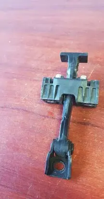 Front door check strap stopper