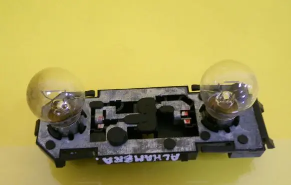 Tail light bulb cover holder