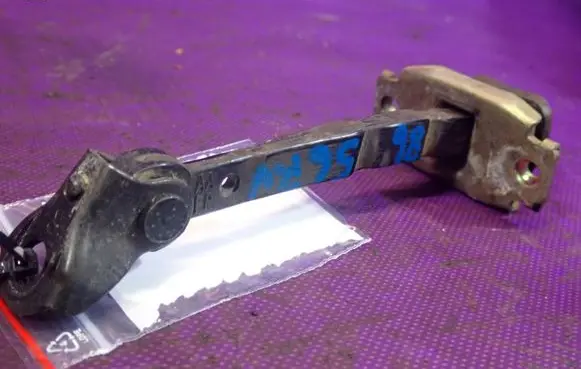 Front door check strap stopper