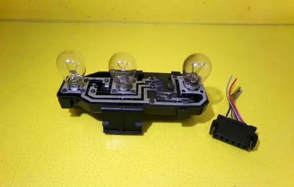 Tail light bulb cover holder