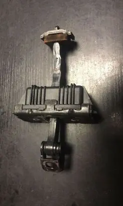 Front door check strap stopper