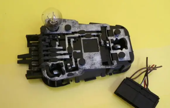 Tail light bulb cover holder