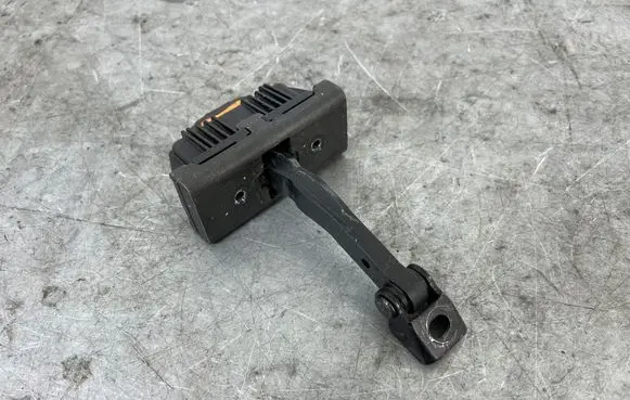 Front door check strap stopper