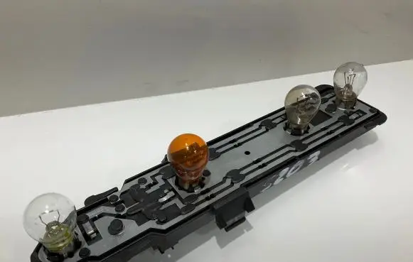 Tail light bulb cover holder