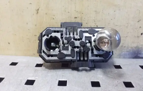 Tail light bulb cover holder