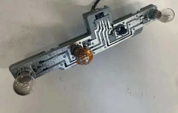 Tail light bulb cover holder