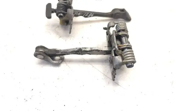 Front door check strap stopper
