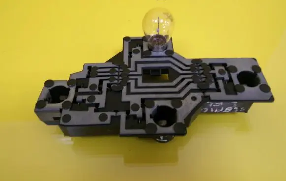 Tail light bulb cover holder