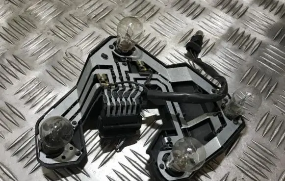 Tail light bulb cover holder