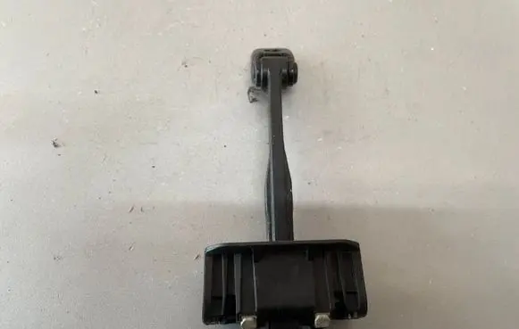 Front door check strap stopper