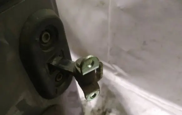 Front door check strap stopper