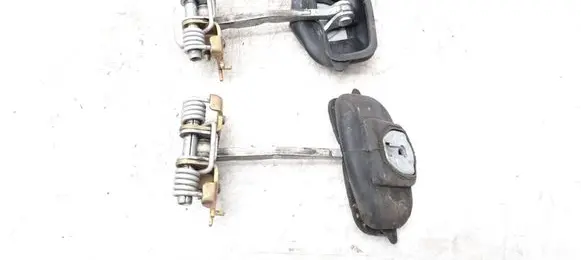 Front door check strap stopper