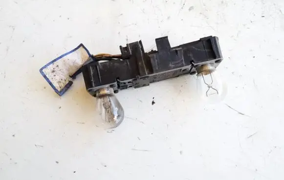 Tail light bulb cover holder