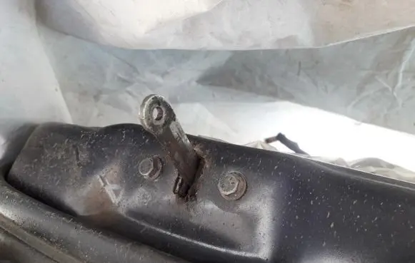 Front door check strap stopper